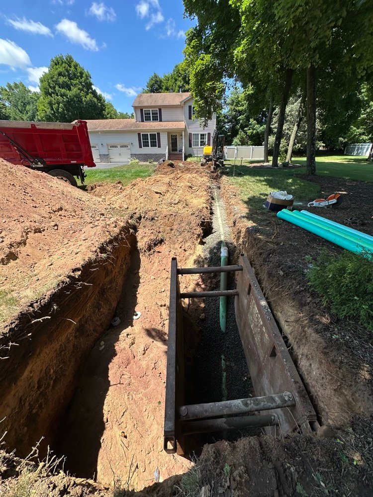 Excavation trench with pipe running to house